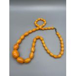 A Vintage Amber graduating bead necklace made from egg yoke/ Butter scotch Amber. [Weighs 61.6grams]