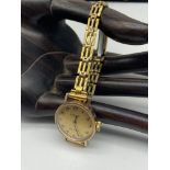 Vintage ladies 9ct gold cased Tissot stylist watch, paired with a rolled gold strap [working]