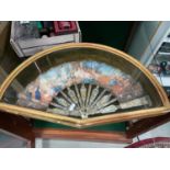 Antique hand painted fan within a fitted glass and gilt painted wood case.