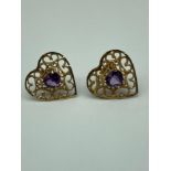 A Pair of 9ct gold heart shaped earrings set with a heart shaped amethyst stone centre. [Weighs 1.41