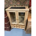 A Contemporary light wood drinks cabinet fitted with interior lighting and marble top.