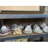 A Shelf of collectable porcelain tea sets which includes Aynsley 'Pembroke' tea set, Kensington