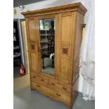 A Large Victorian light oak single mirror door wardrobe. Designed with hook interior and two over