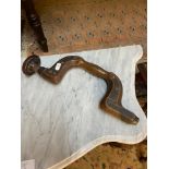 A Victorian hand held drill made from wood and brass inlay panels. Small white circle with the