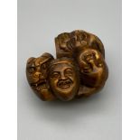 Japanese hand carved netsuke of seven various masks. Signed by the artist. [4.5cm length]