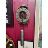 A Vintage Tempus Fugit skeleton wall clock with weight and pendulum.