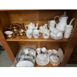 Two Shelves of porcelain tea sets and part sets which include Poland designed tea set, Royal