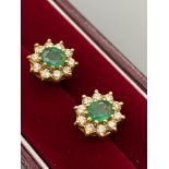 A Pair of ladies 18ct gold emerald and diamond earrings. [3.55grams]