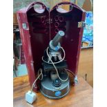 A Vintage C Baker London microscope within a fitted travel case