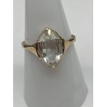 An Antique ladies 9ct gold ring set with a large clear glass stone. [Weighs 2.21 grams] [Ring size