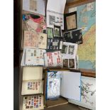 A collection of first day covers and various stamps from around the world.