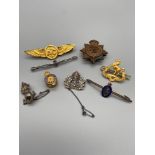 A Collection of Military R.A.F, Naval and army brooches and cap badges, Which includes Silver