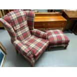 A Tartan upholstered wing back arm chair with matching footstool