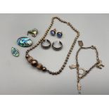 A Lot of silver jewellery which includes three Sterling silver and Paua shell brooches and