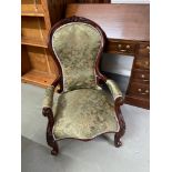 A lovely example of Victorian fire side spoon back chair. Designed with arm rests. Mahogany frame.