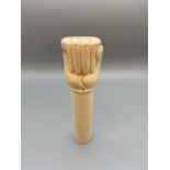 A Japanese Meiji period bone carved clenched fist walking stick handle. Signed by the artist. [