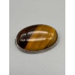A Lovely example of a ladies tiger eye brooch, set within a silver brooch/ pendant frame. [Stone