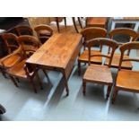 A Victorian farm house dining table together with a matching 7 dining chairs and the head of the