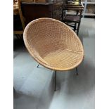 A Retro wicker weaved tub chair designed with metal base and legs.