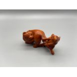 A Hand carved Japanese netsuke of a mouse pulling a cat tail. Signed by the artist. Both detailed