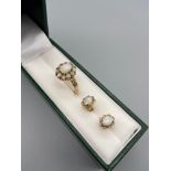 Ladies 9ct gold ring set with a large opal stone centre off set by a second tier of 10 smaller