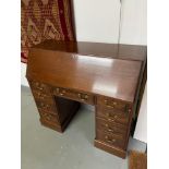 A Reproduction Antique style knee hole writing bureau with blue leather writing area. Four drawers