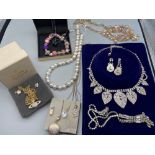 A Lot of vintage silver and costume jewellery which includes four silver chains with silver