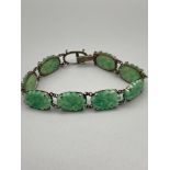 A Vintage Chinese export 935 silver and Jade carved bracelet. [Missing one stone]