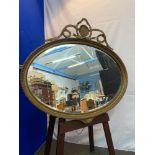 A Regency moulded gilt framed oval bevel edge mirror. [75x83cm]