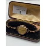 Antique ladies 9ct gold Oriosa watch and 9ct gold elasticated strap bracelet. Watch is in a