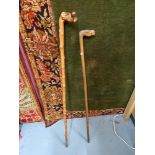 A lot of two antique walking canes. One designed with a hand carved horse head handle.