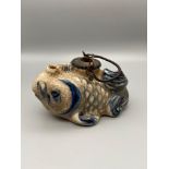 A Japanese crackle glazed blue and white koi carp saki tea pot. Together with an ornate glass sphere