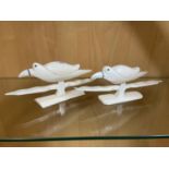 A Pair of 19th century hand carved birds sat upon perches.