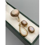 A Ladies 9ct gold ring set with a large opal stone, a pair of 9ct gold and opal stone earrings and a