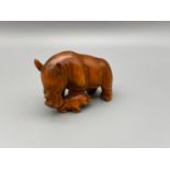 Japanese hand carved netsuke of a mother rhino and baby rhino, both designed with black bead eyes