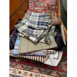 A Collection of various tartan material for upholstery.