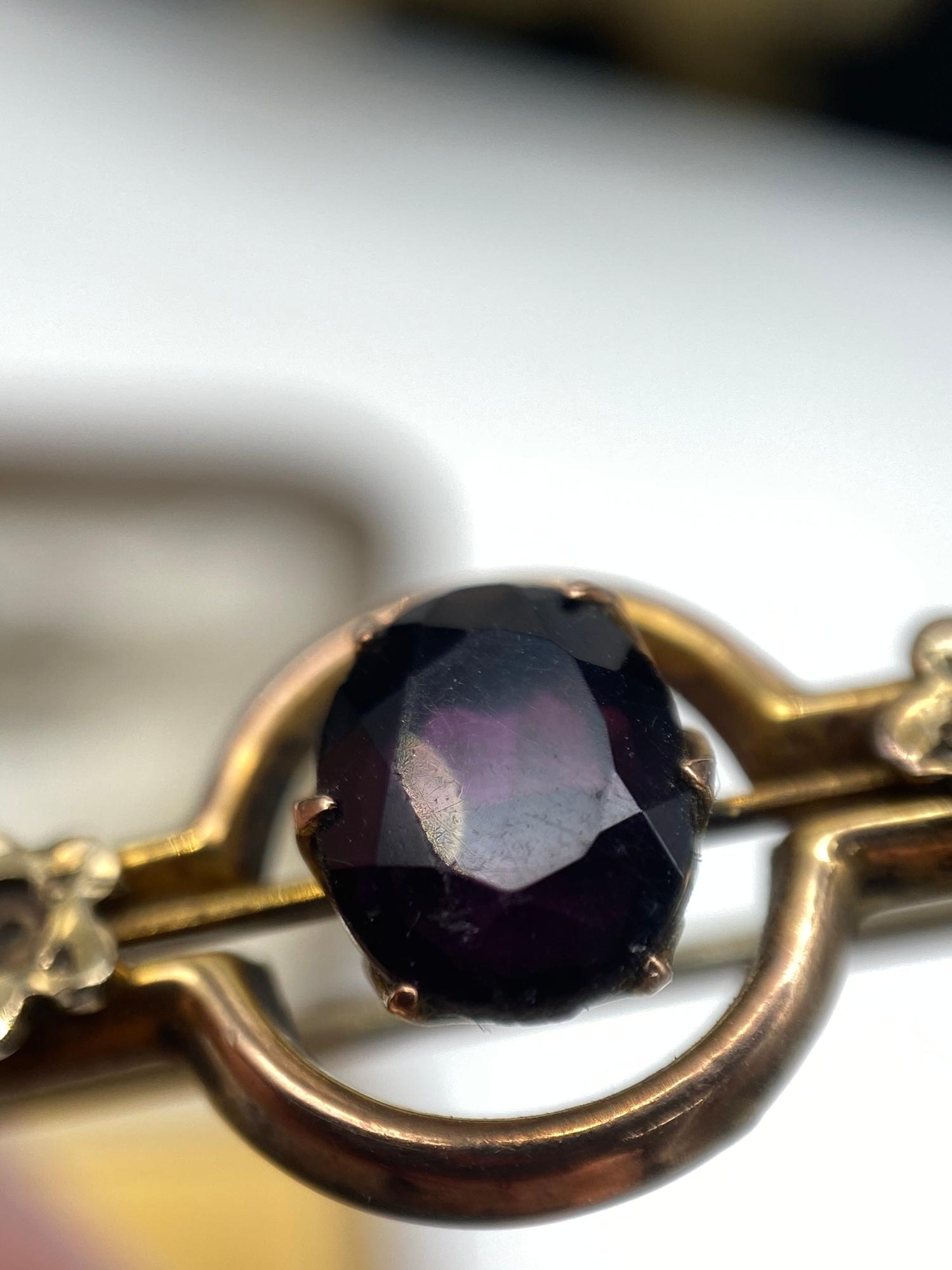 A Ladies antique 9ct gold bar brooch set with three seed pearls [one missing] and a large Amethyst - Image 4 of 5