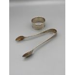 A Pair of Birmingham silver sugar tongs made by Thomas Hayes and dated 1891 together with a