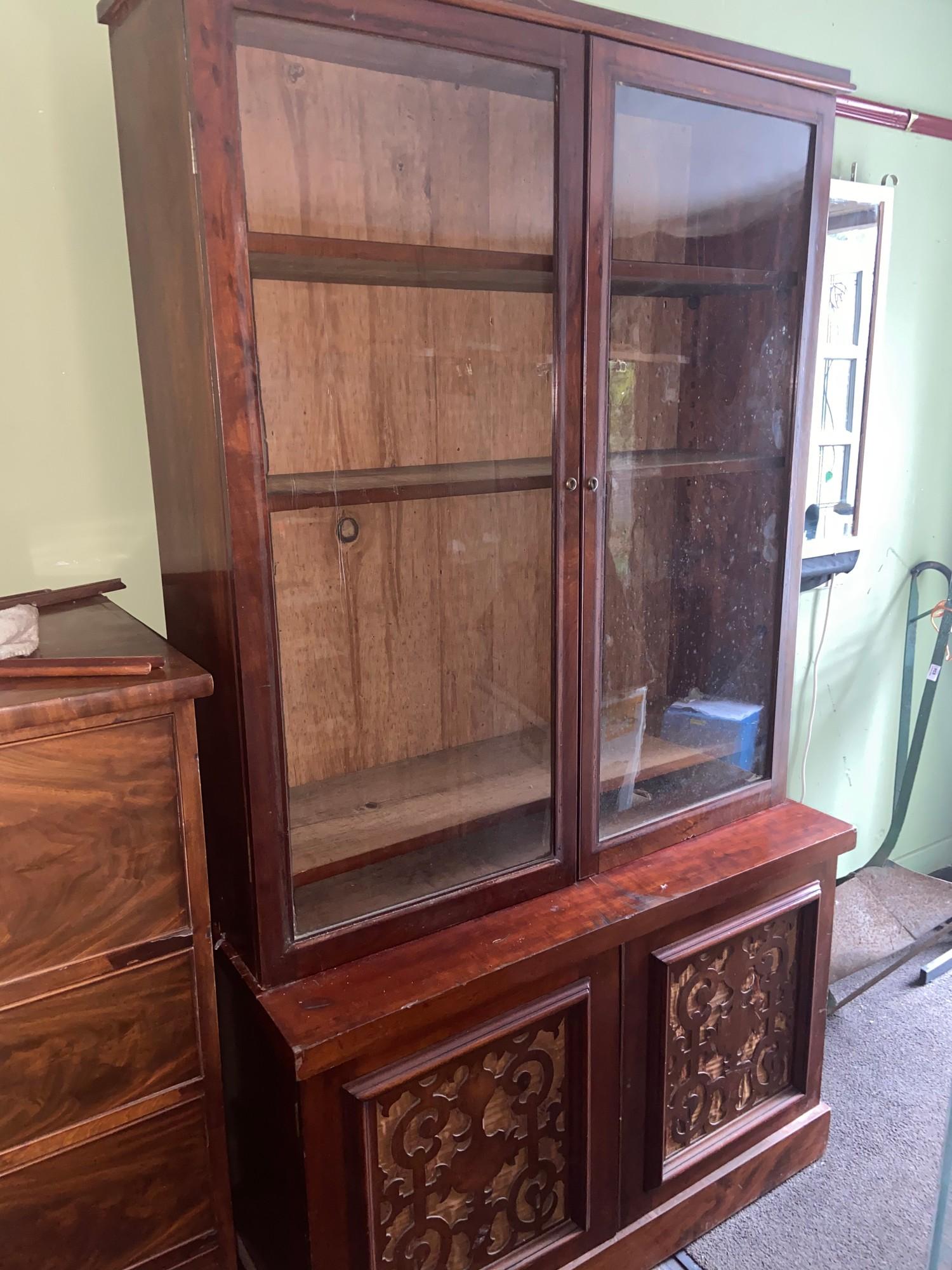 A Victorian Mahogany two piece library bookcase. Designed with glass double doors.