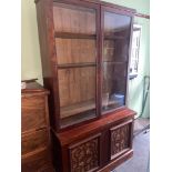 A Victorian Mahogany two piece library bookcase. Designed with glass double doors.