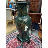 A Large Green Lacquered Oriental urn vase sat upon a matching stand. Designed with raised relief