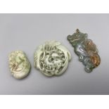 A Lot of three Chinese hand carved jade sculptures which includes a dragon carved pendant, Ox carved