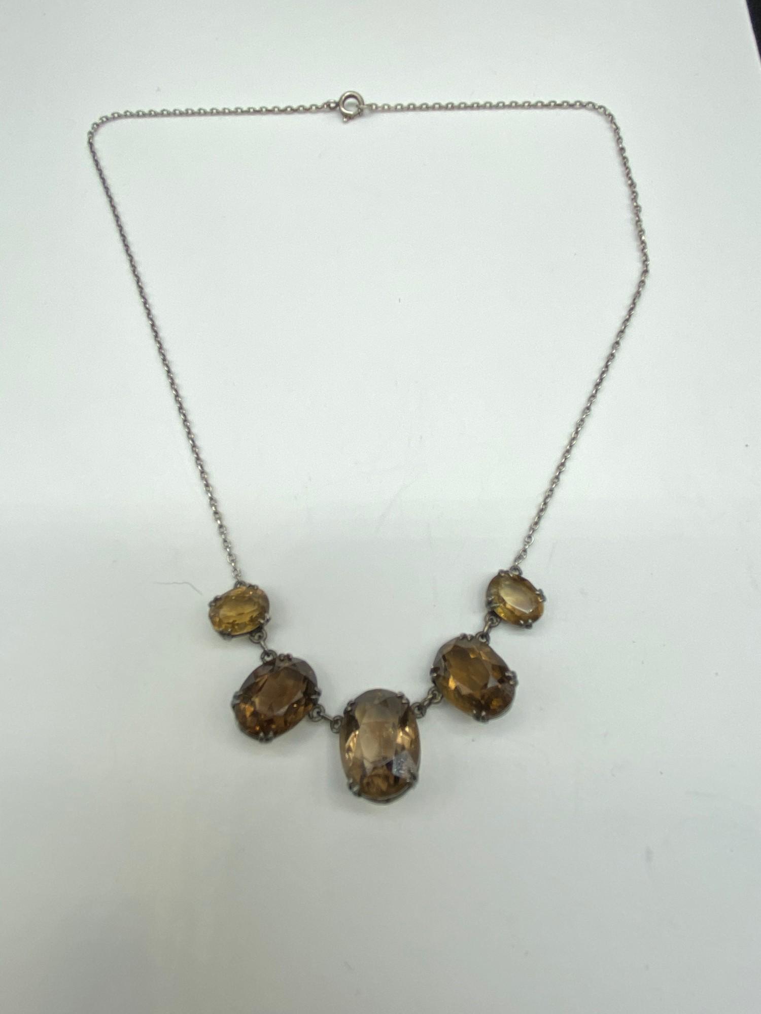 A Lovely example of an Antique ladies silver and smokey quartz drop necklace. Consists of five