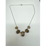 A Lovely example of an Antique ladies silver and smokey quartz drop necklace. Consists of five