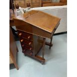 A Late Victorian Davenport writing desk, designed with four side drawers and four false drawers.