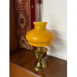 A Vintage brass and amber glass paraffin lamp