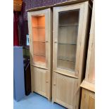 A Pair of contemporary light wood ercol display cabinets. [230x61x30cm]