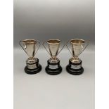 A Lot of three Miniature Birmingham silver two handle trophies with stands