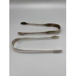 Two pairs of Georgian Edinburgh silver sugar tongs. Maker of one set is Alexander Edmonstoun II