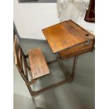 Antique Child's School desk made from oak and cast metal. Has a lift up top and ink well area.
